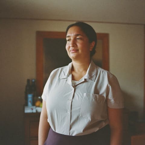A bilingual carer in a home setting, illustrative.